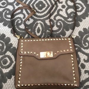 Charming Charlie cross body gold grommet bag